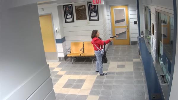 Footage shows Suzanne Laprise in the lobby flashing and slamming a handgun several times on the glass.